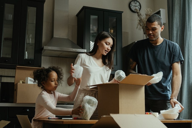 family with moving boxes property management coburg